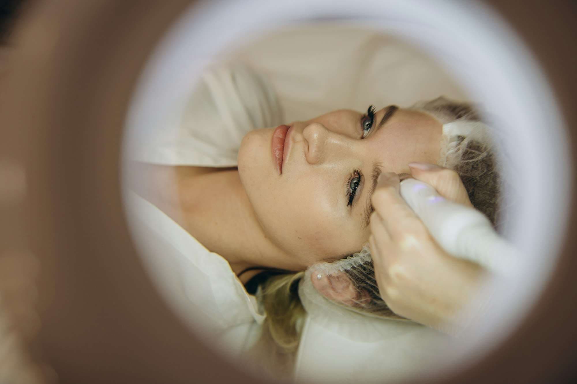 Woman receiving hydro microdermabrasion facial treatment