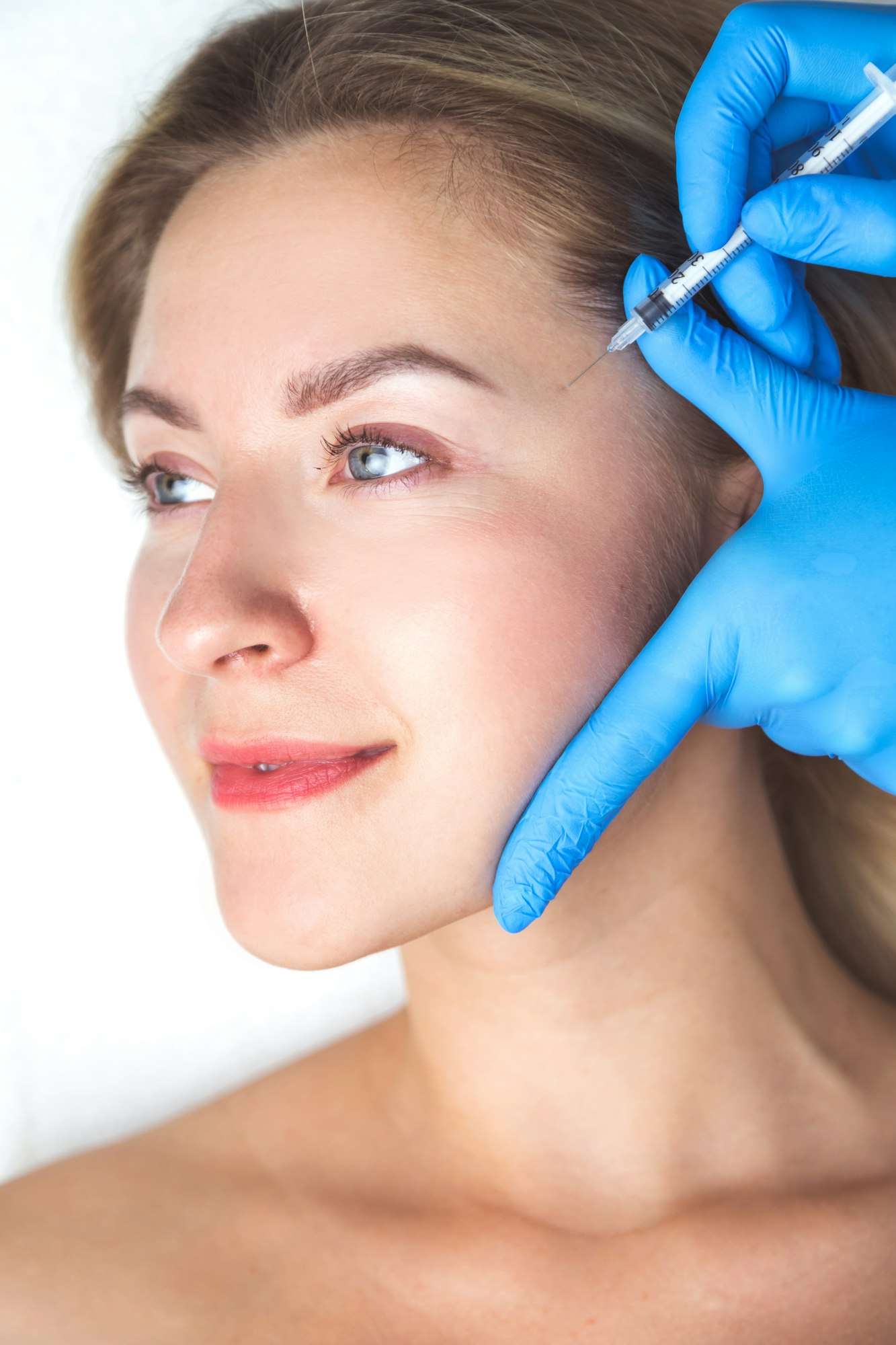 Patient receiving Morpheus8 RF microneedling facial treatment