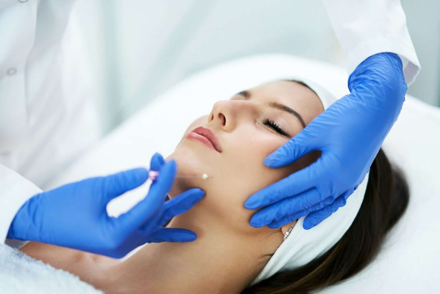Woman receiving PDO thread lifting treatment at beauty clinic