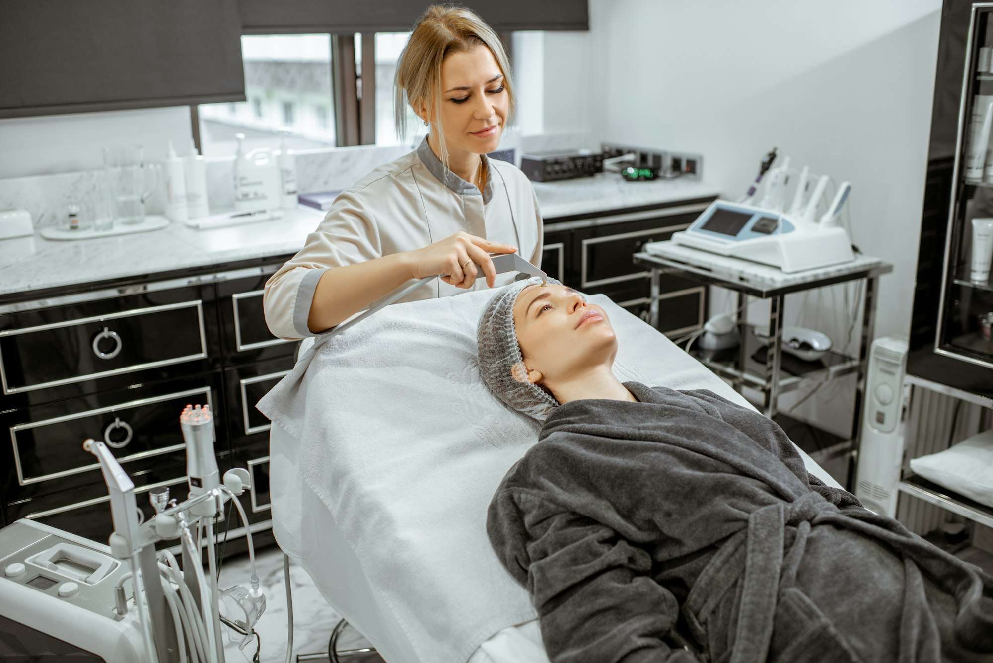 Woman receiving relaxing hydro facial treatment at a spa