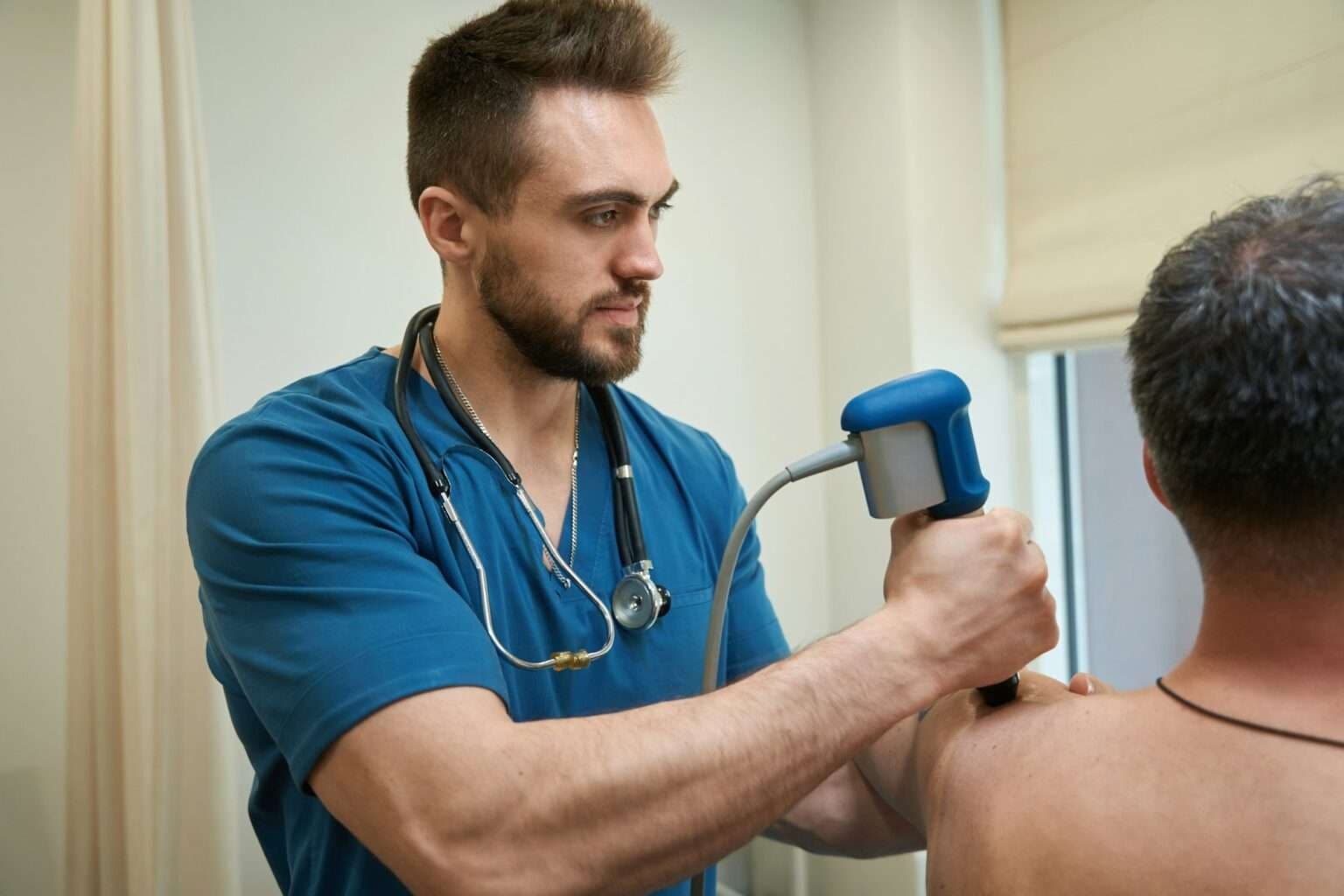 Physical therapist conducting extracorporeal shockwave therapy