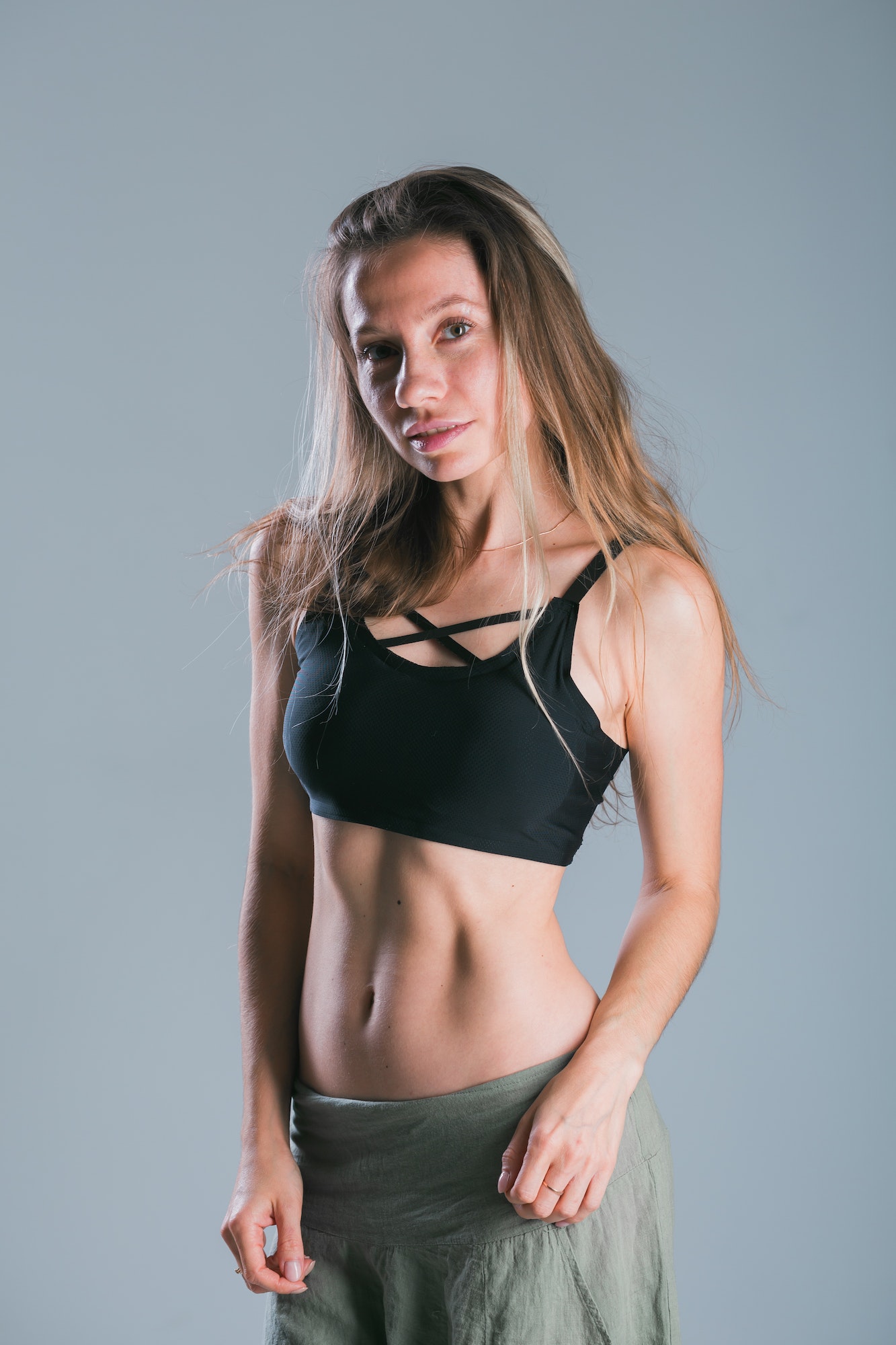 Fitness and diet concept. Portrait of young woman with perfect sporty body and pretty flat abs in